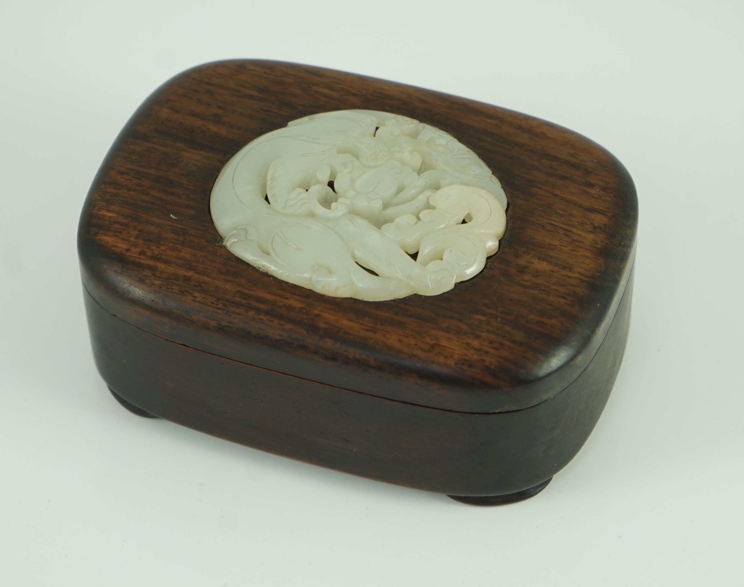 A Chinese white jade openwork plaque, 17th/18th century, later inset into a hongmu box Jade 6.2cm, box 11.5 cm